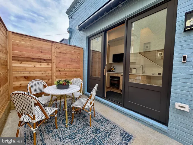 a outdoor dining space with furniture and a potted plant