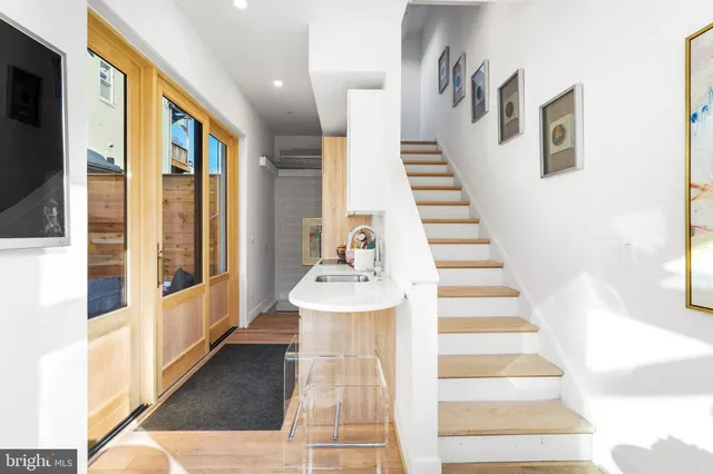 a view of entryway and hall with wooden floor