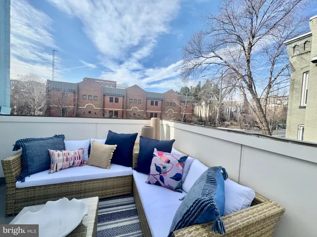 a view of a roof deck with furniture