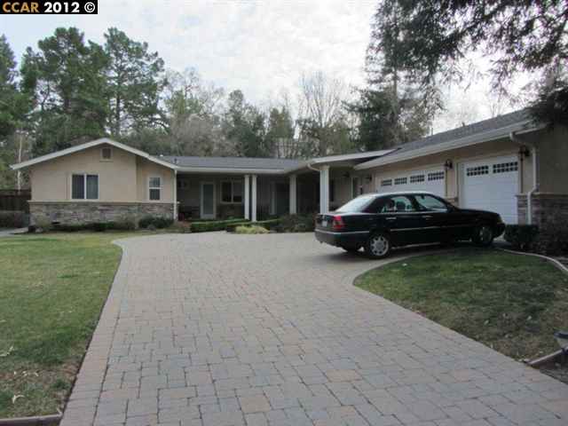 a car parked in front of a house with a garden