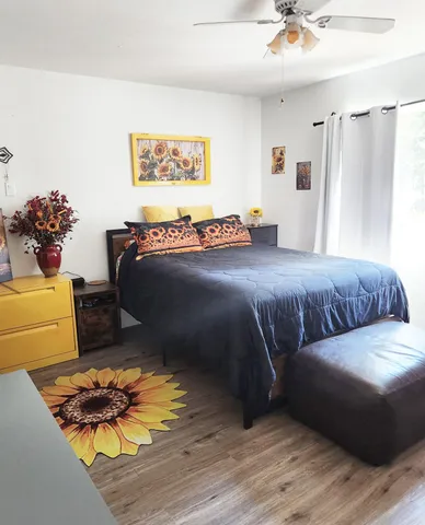 a bedroom with a bed and a chandelier
