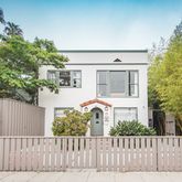 a front view of a house with a garden