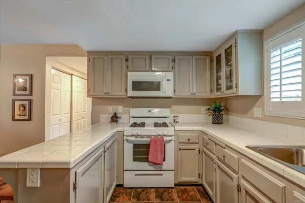 a kitchen with a sink stove and microwave
