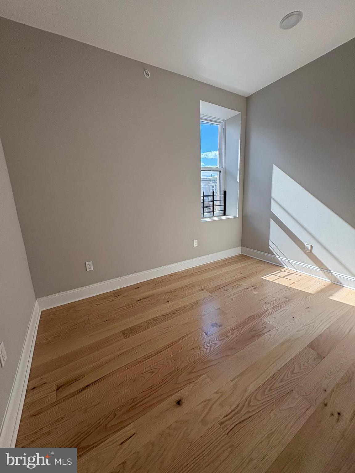 2900 North 5th Street, Unit 3 Philadelphia, PA 19133 - Photo 2 of 7 a view of an empty room with wooden floor and a window