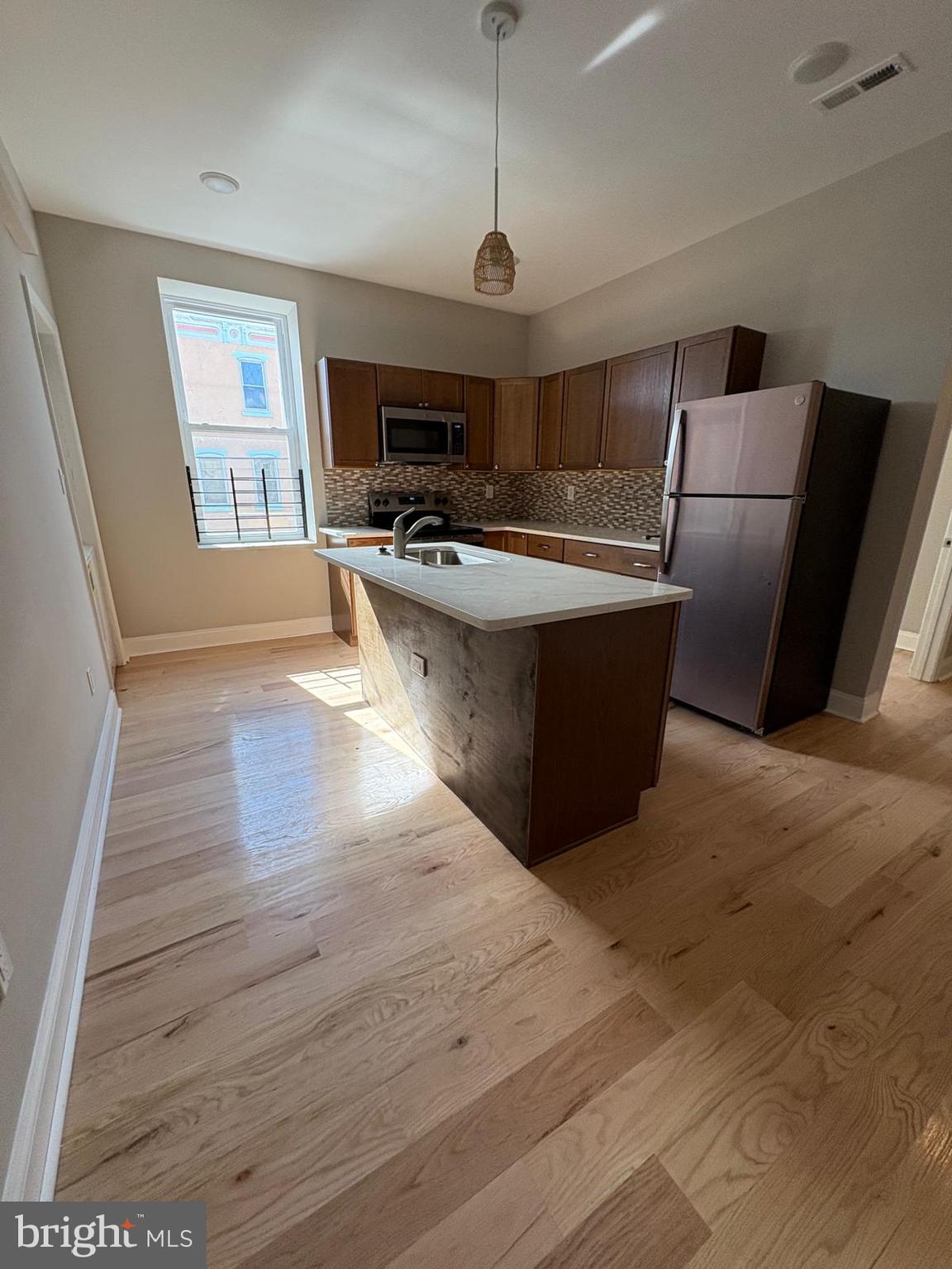 2900 North 5th Street, Unit 3 Philadelphia, PA 19133 - Photo 3 of 7 a kitchen with stainless steel appliances granite countertop a sink a stove and a wooden floors