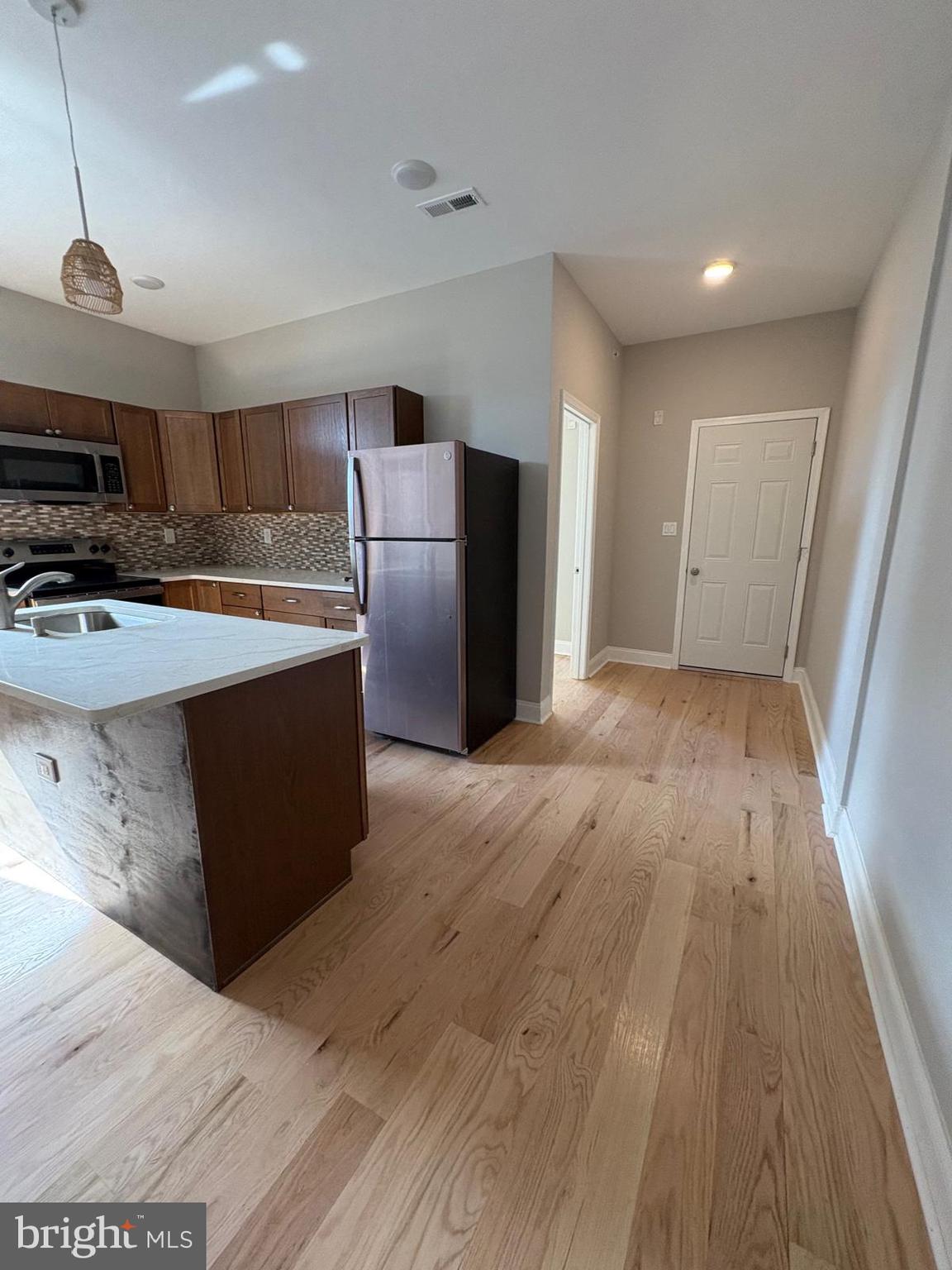 2900 North 5th Street, Unit 3 Philadelphia, PA 19133 - Photo 5 of 7 a kitchen with stainless steel appliances a refrigerator and a stove top oven
