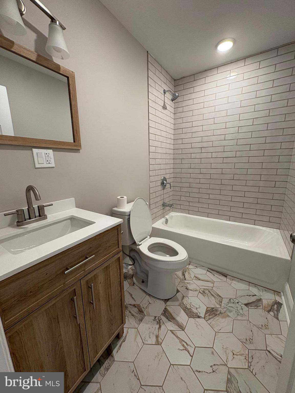 2900 North 5th Street, Unit 3 Philadelphia, PA 19133 - Photo 6 of 7 a bathroom with a sink a toilet and shower