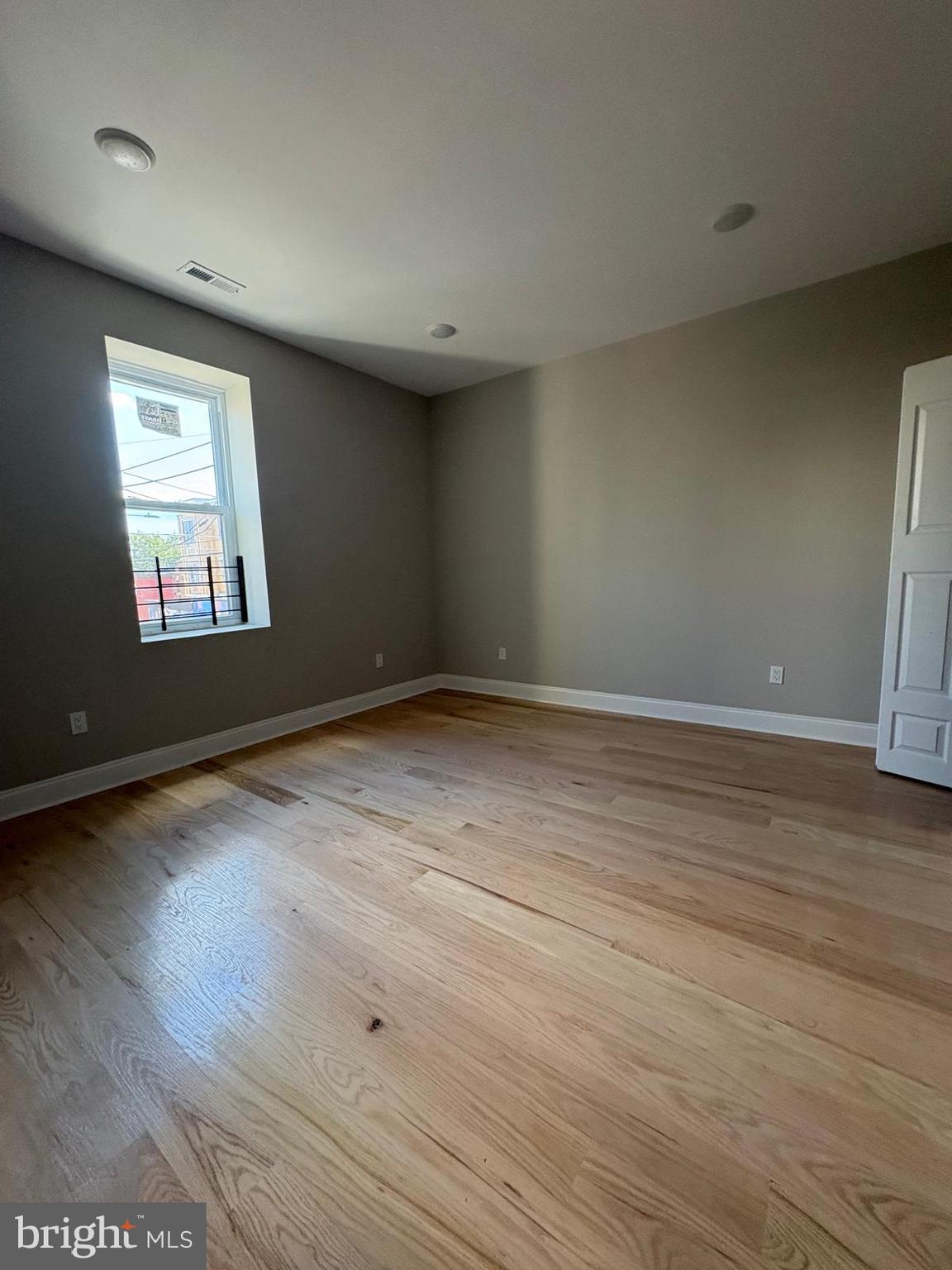 2900 North 5th Street, Unit 3 Philadelphia, PA 19133 - Photo 7 of 7 an empty room with wooden floor and windows
