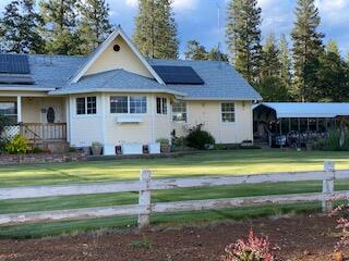 37268 Vedder Road Burney, CA 96013 - Photo 3 of 29 a front view of a house with swimming pool having outdoor seating