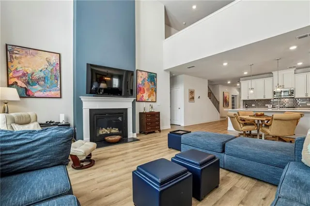 a living room with furniture and kitchen view