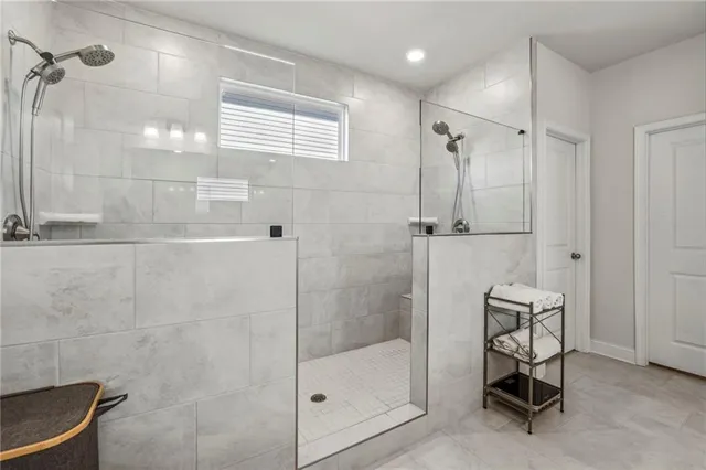 a view of walk in closet with clothes