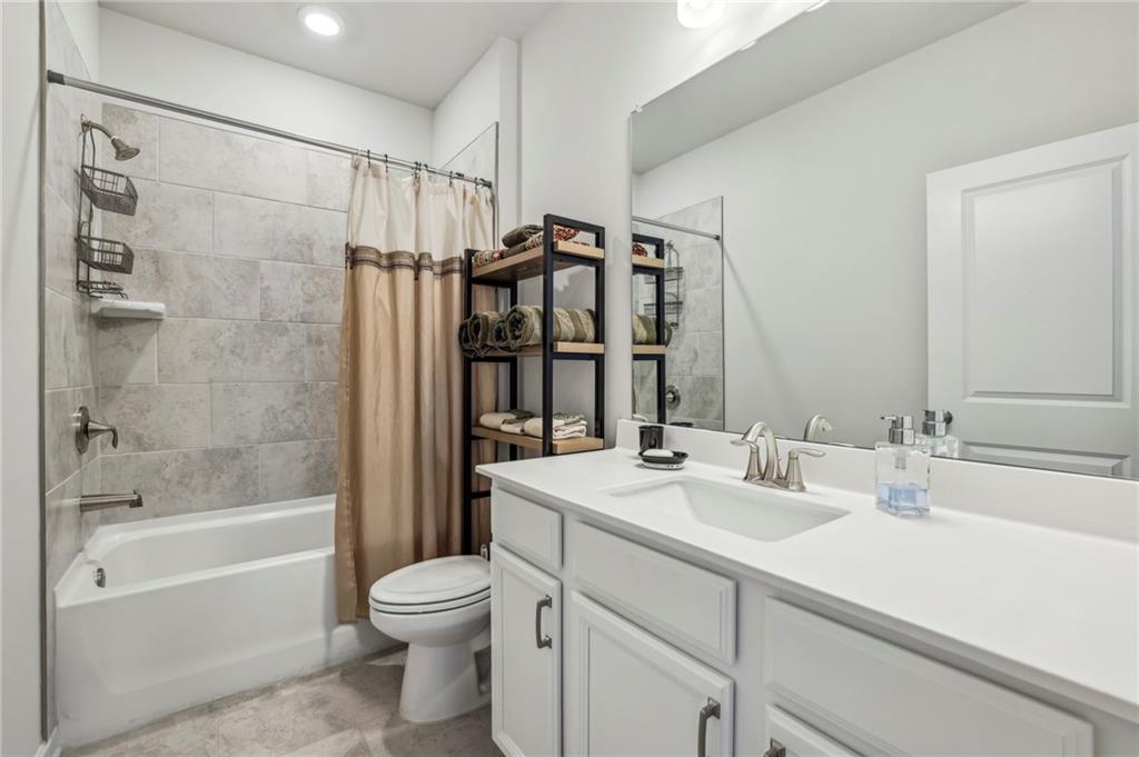4257 Freight Street Tucker, GA 30084 - Photo 29 of 41 a bathroom with a bathtub shower sink vanity and toilet