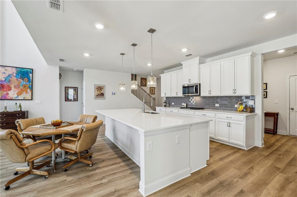4257 Freight Street Tucker, GA 30084 - Photo 8 of 41 a kitchen with stainless steel appliances kitchen island granite countertop a sink and cabinets