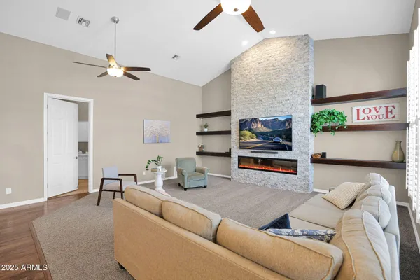 a living room with furniture a rug and a window