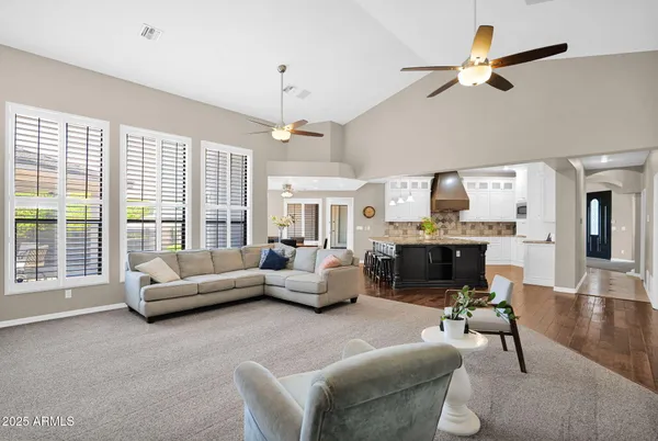 a kitchen with a sink a chandelier dining table and chairs