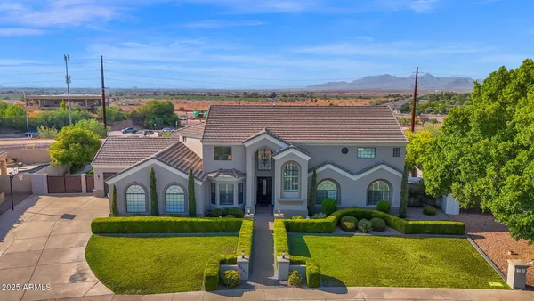 an aerial view of residential houses with outdoor space and parking