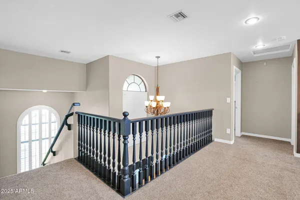 a living room with furniture and a ceiling fan
