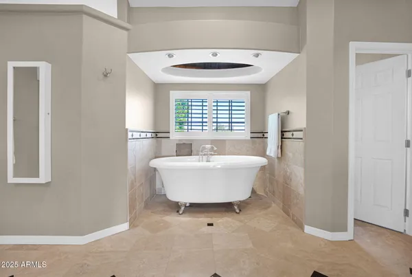 a view of a patio with table and chairs under an umbrella