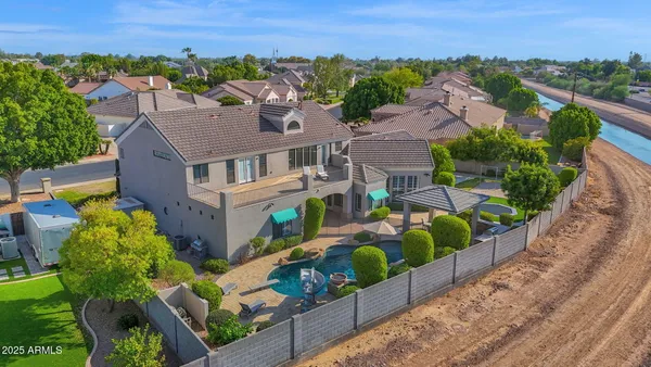 a living room with stainless steel appliances kitchen island granite countertop furniture a sink a stove and a wooden floors