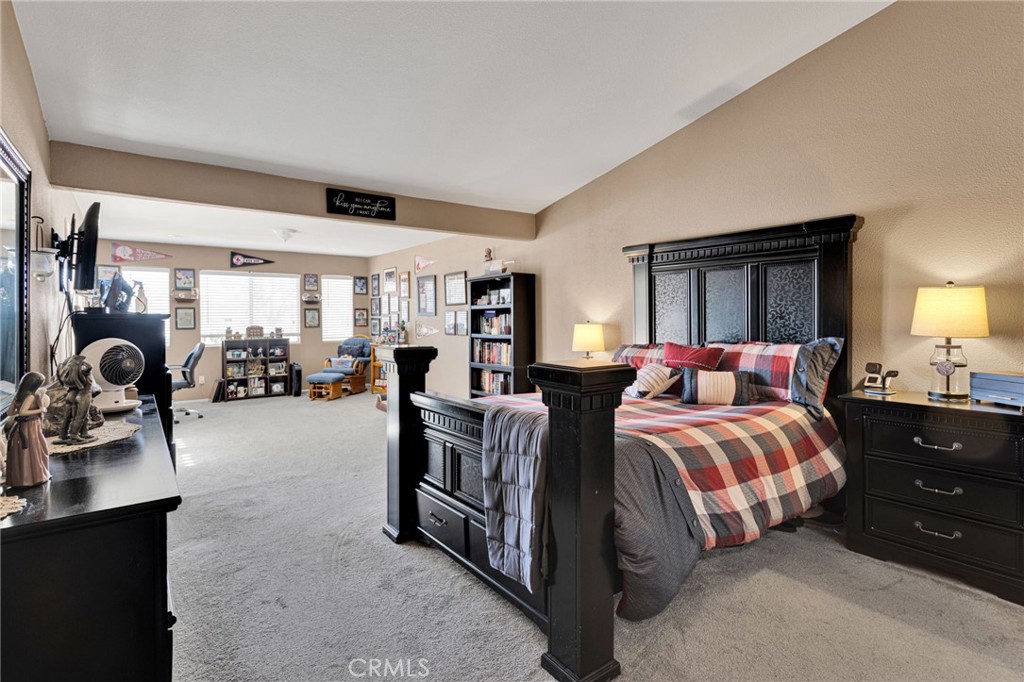20403 Ochoa Road Apple Valley, CA 92307 - Photo 28 of 48 a spacious bedroom with a bed and a dresser next to a window