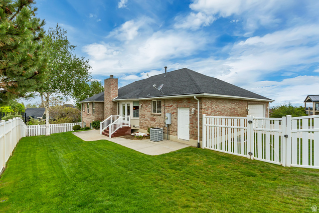 298 North Canyon Road Bountiful, UT 84010 - Photo 52 of 57 Spacious backyard featuring a lush green lawn, full privacy fencing, and mature trees