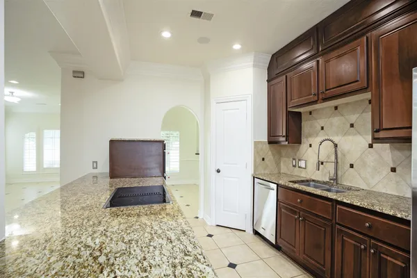 a spacious bathroom with stainless steel appliances granite countertop a sink and a granite counter tops