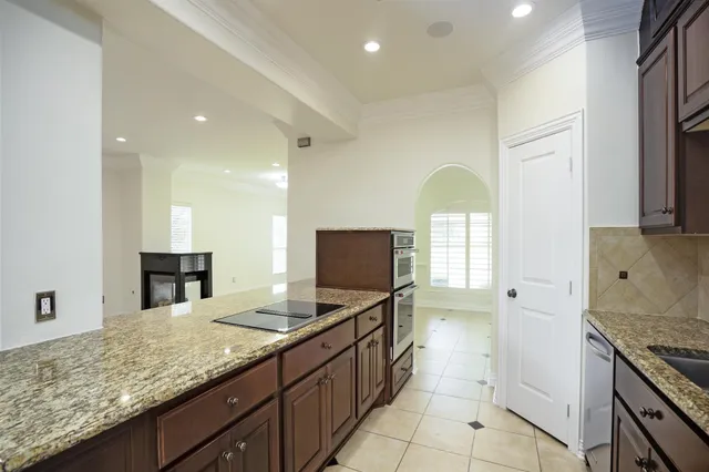 a kitchen with granite countertop a sink and a stove