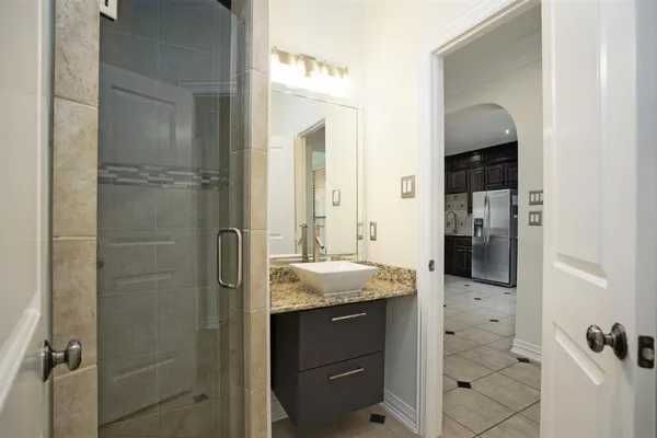 a bathroom with a granite countertop sink and mirror