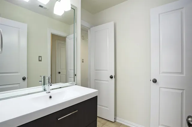 a bathroom with a sink and mirror