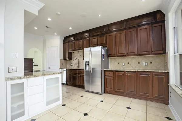 a kitchen with granite countertop cabinets and steel stainless steel appliances