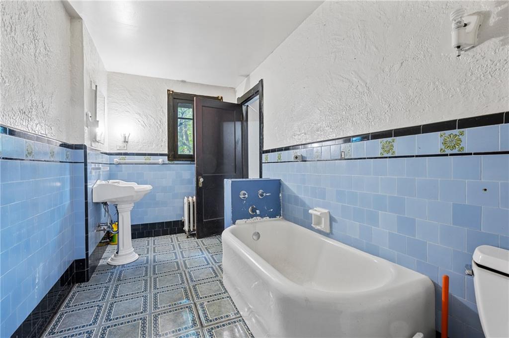 717 Center Pittsburgh, PA 15215 - Photo 16 of 20 a bathroom with a sink a toilet and bathtub