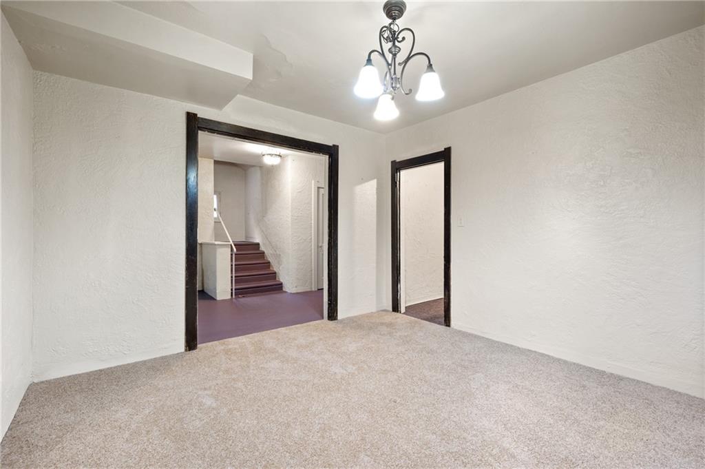 717 Center Pittsburgh, PA 15215 - Photo 2 of 20 a view of a hallway with wooden floor and chandelier