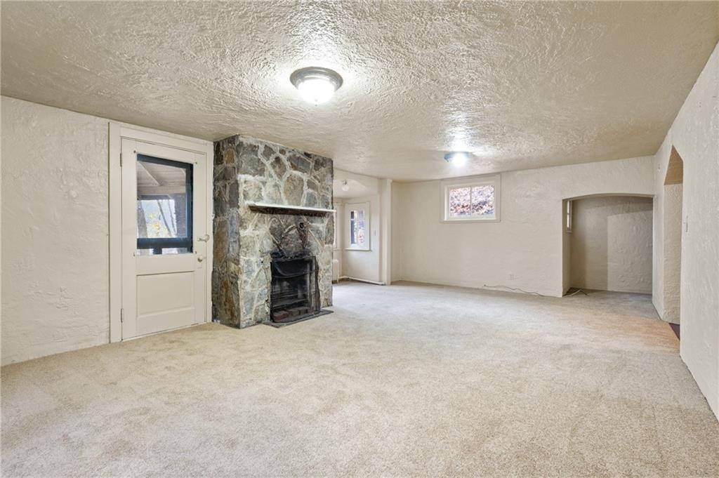 717 Center Pittsburgh, PA 15215 - Photo 7 of 20 an empty room with furniture and a fireplace