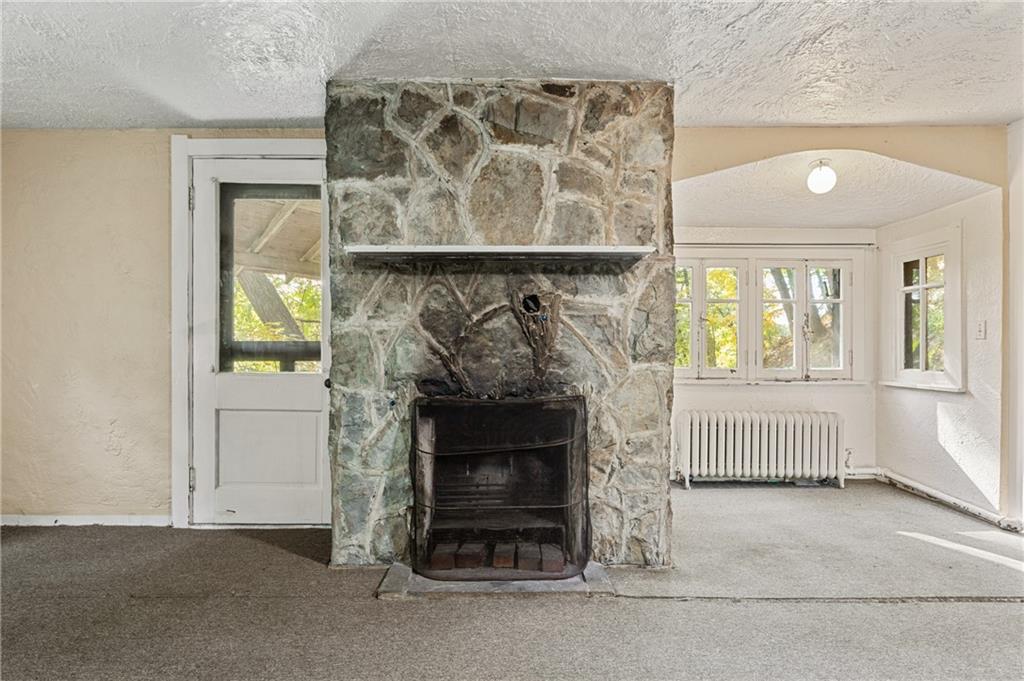 717 Center Pittsburgh, PA 15215 - Photo 8 of 20 an empty room with fireplace and windows