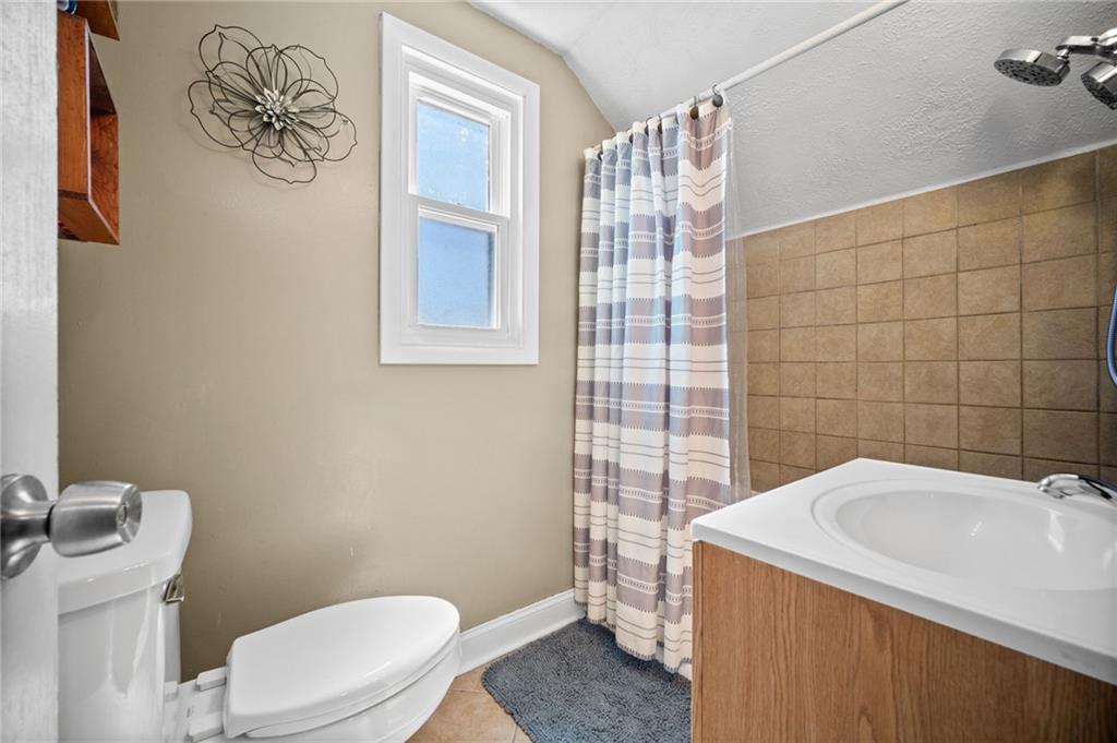 4030 Lebanon Church Road West Mifflin, PA 15122 - Photo 26 of 45 a bathroom with a sink a toilet and a mirror