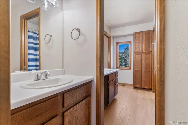 an aerial view of residential house with outdoor space and trees all around