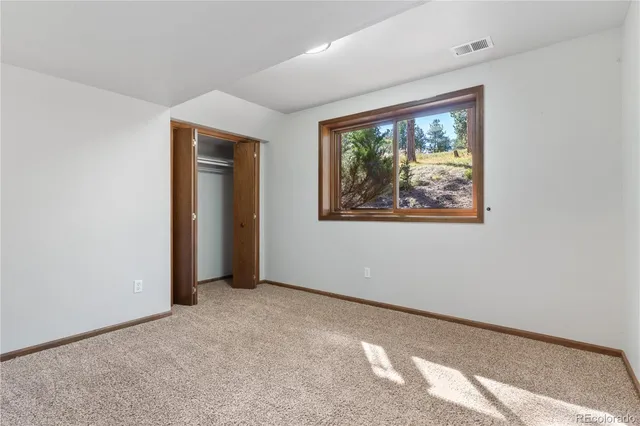 a view of a lush green hillside and houses