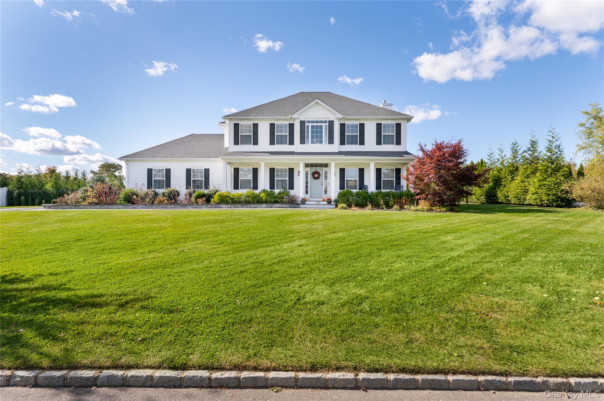 108 Calverton Court Wading River, NY 11792 - Photo 1 of 36 a front view of a house with a garden