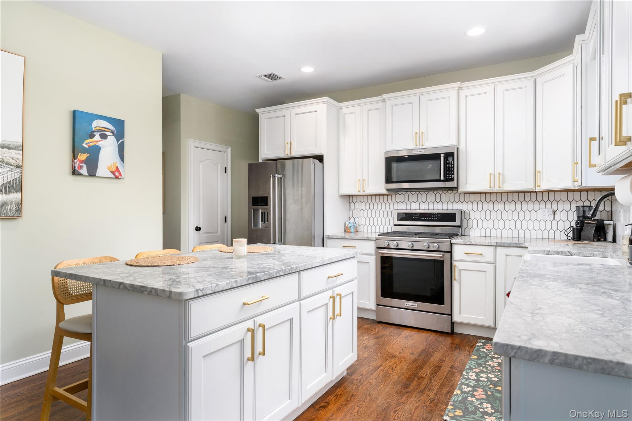 108 Calverton Court Wading River, NY 11792 - Photo 11 of 36 a kitchen with a sink stove and refrigerator