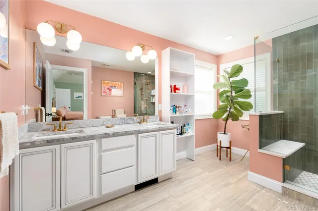 a bathroom with a double vanity sink and a mirror
