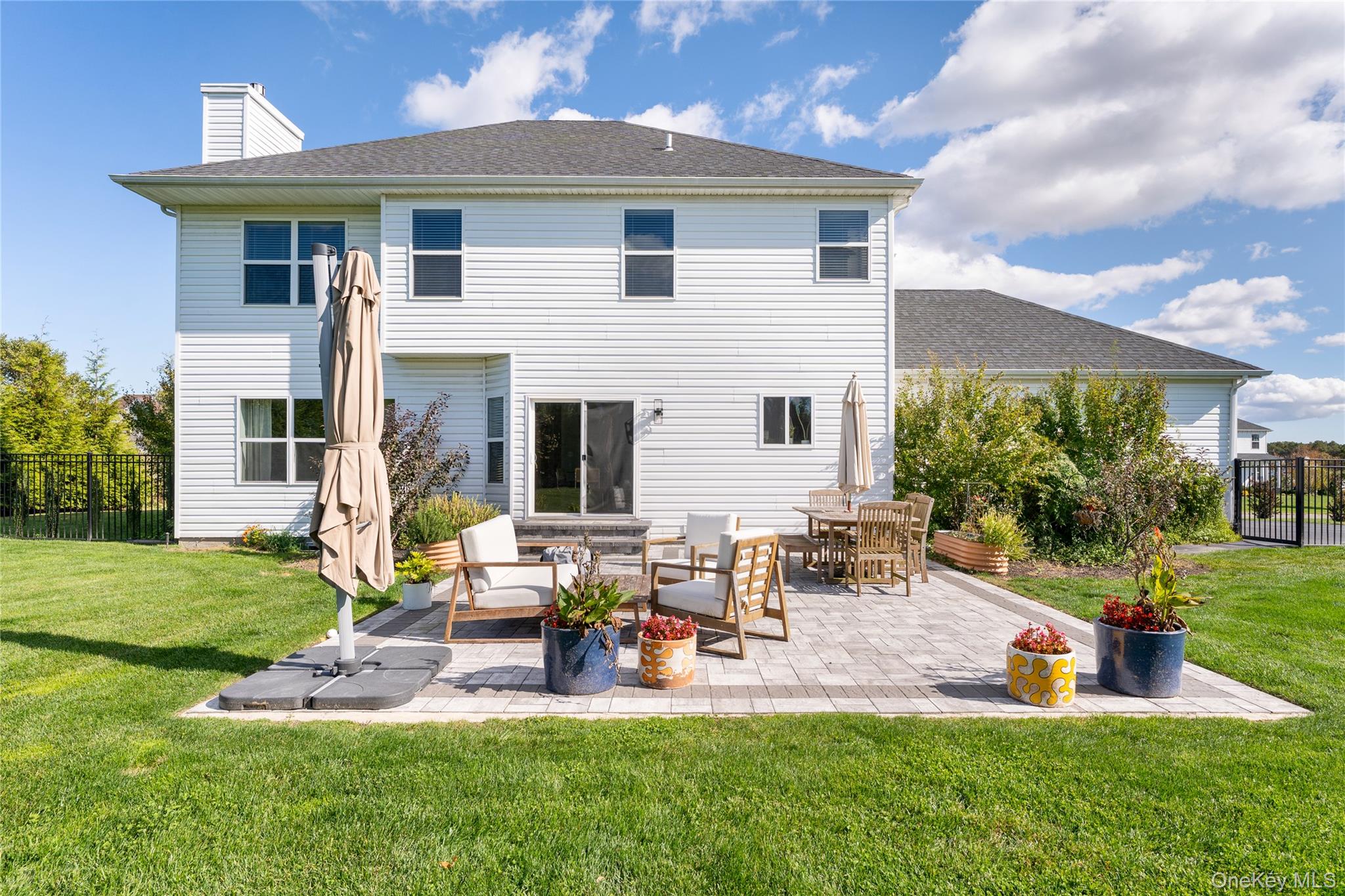 108 Calverton Court Wading River, NY 11792 - Photo 28 of 36 a front view of a house with garden and sitting area
