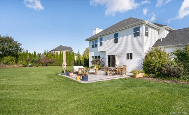 a view of a house with backyard sitting area and garden