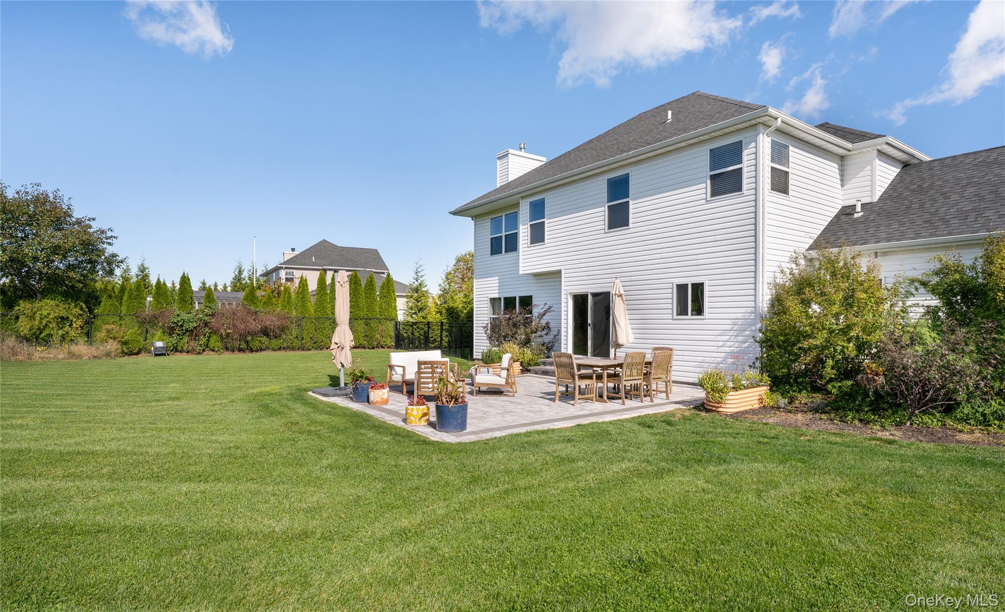 108 Calverton Court Wading River, NY 11792 - Photo 29 of 36 a view of a house with backyard sitting area and garden