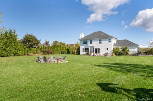 a front view of a house with a yard table and chairs