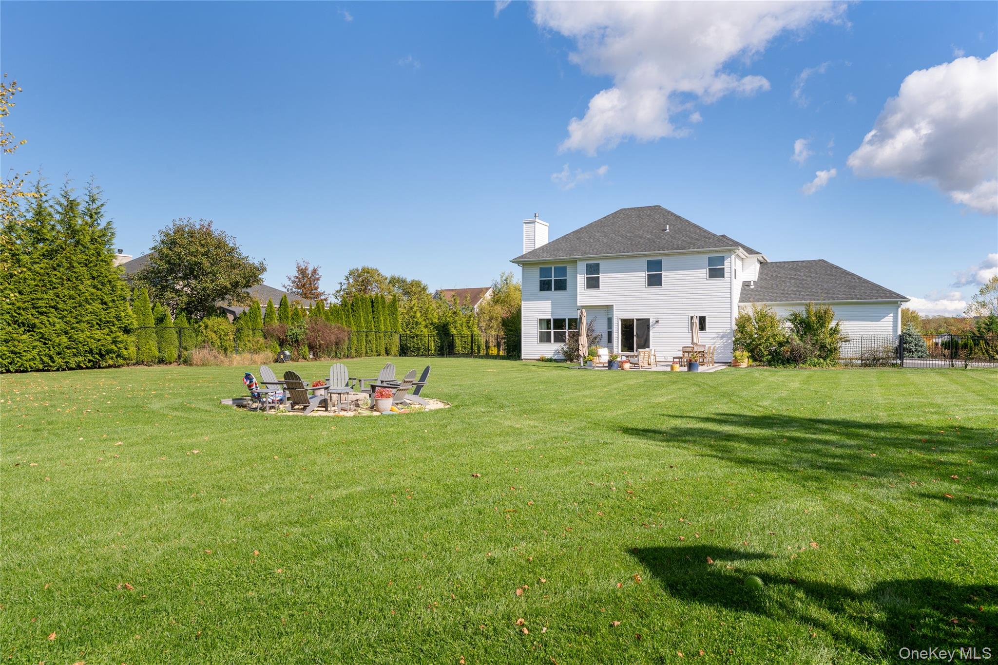 108 Calverton Court Wading River, NY 11792 - Photo 33 of 36 a front view of a house with a yard table and chairs