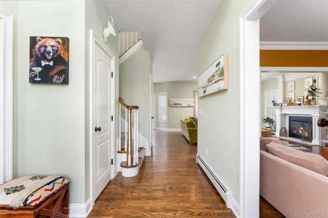 a view of a hallway to a livingroom with furniture