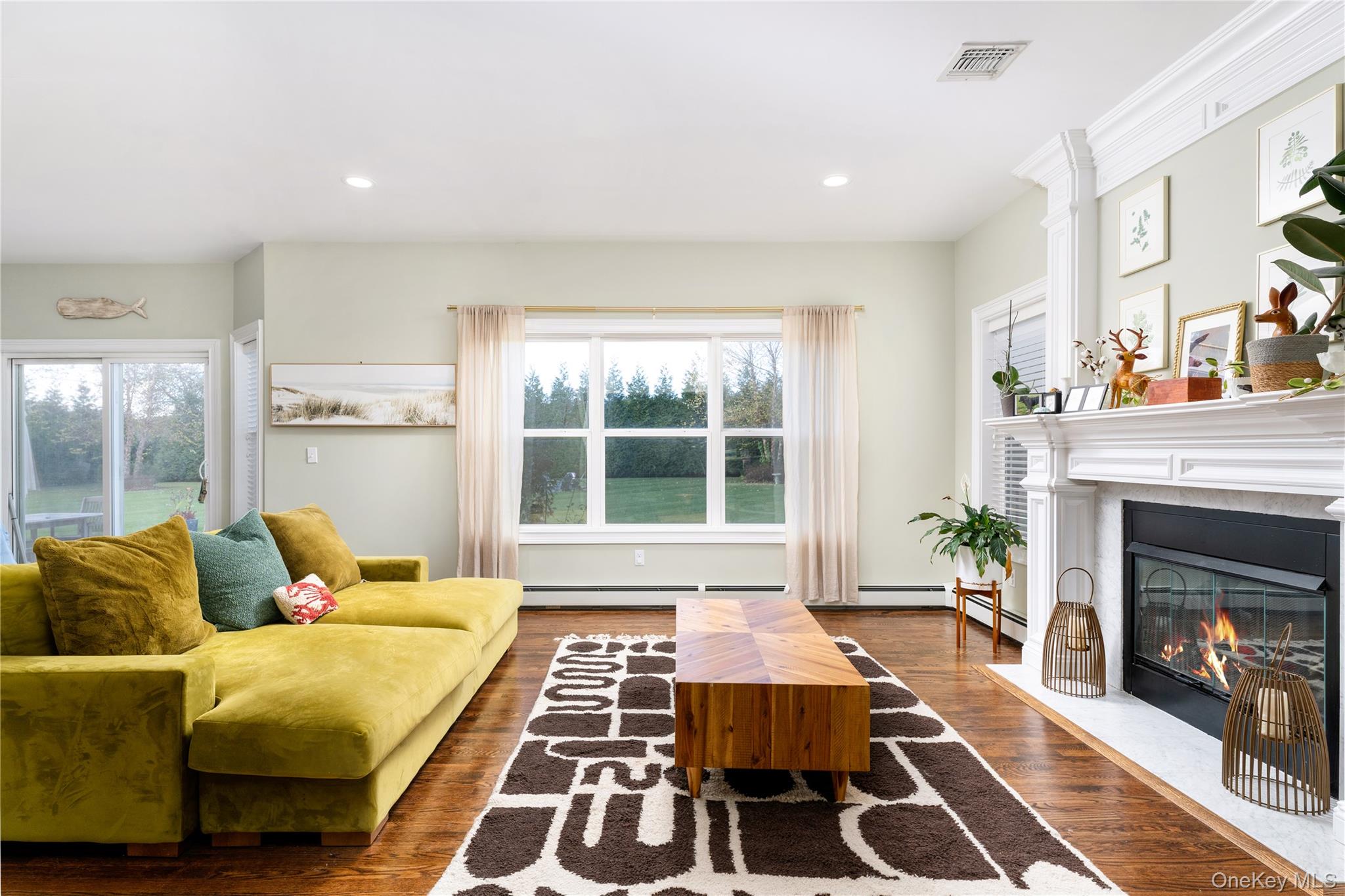 108 Calverton Court Wading River, NY 11792 - Photo 8 of 36 a living room with furniture and a fireplace
