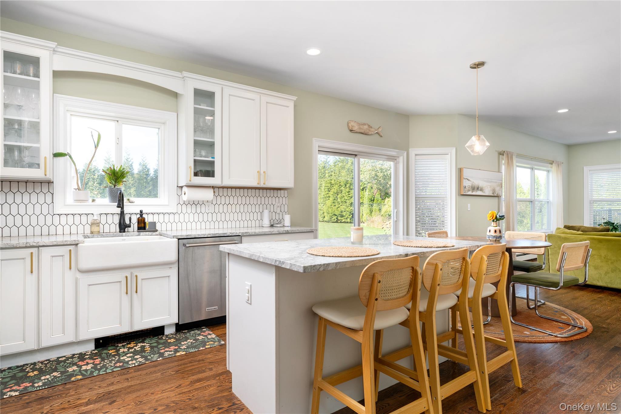 108 Calverton Court Wading River, NY 11792 - Photo 10 of 36 a kitchen with a table chairs sink and cabinets