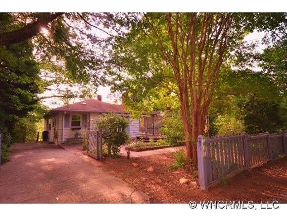 231 Woodland Road Tryon, NC 28782 - Photo 1 of 24 a view of a house with a tree in the background