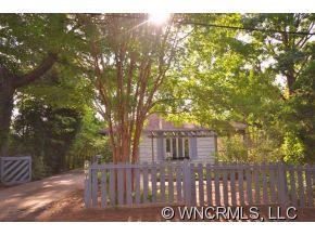 231 Woodland Road Tryon, NC 28782 - Photo 2 of 24 a view of a wooden house with a yard